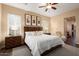 A bedroom features a ceiling fan, a large bed, neutral walls, and a gray rug at 12715 W Crestvale Dr, Peoria, AZ 85383