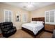 A well-lit bedroom features plantation shutters, carpet, and a ceiling fan at 12715 W Crestvale Dr, Peoria, AZ 85383