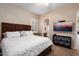 A bedroom features an ensuite bathroom, a wall mounted TV and a ceiling fan at 12715 W Crestvale Dr, Peoria, AZ 85383