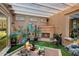 Outdoor courtyard featuring synthetic grass, a fireplace, and a covered patio at 12715 W Crestvale Dr, Peoria, AZ 85383
