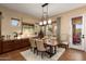 A formal dining room features a wooden table and neutral colored walls and decor at 12715 W Crestvale Dr, Peoria, AZ 85383