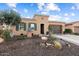 Charming single-story home with desert landscaping, a two-car garage and a blue sky at 12715 W Crestvale Dr, Peoria, AZ 85383