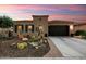 Charming single-story home with desert landscaping, a two-car garage and a beautiful sunrise sky at 12715 W Crestvale Dr, Peoria, AZ 85383