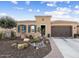 Charming single-story home with desert landscaping, a two-car garage and a blue sky at 12715 W Crestvale Dr, Peoria, AZ 85383