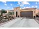 Charming single-story home with desert landscaping, a two-car garage and a blue sky at 12715 W Crestvale Dr, Peoria, AZ 85383
