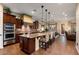 Open-concept kitchen with a center island, granite countertops, stainless appliances, and pendant lighting at 12715 W Crestvale Dr, Peoria, AZ 85383