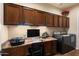 Functional laundry area with ample counter space, cabinetry, and modern washer and dryer at 12715 W Crestvale Dr, Peoria, AZ 85383