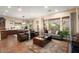 Open-concept living area with tile floors, neutral walls, comfortable furnishings, and large windows at 12715 W Crestvale Dr, Peoria, AZ 85383