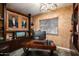 Inviting office with built-in shelving, modern lighting, and a warm, textured wall finish at 12715 W Crestvale Dr, Peoria, AZ 85383
