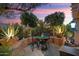 Enchanting patio setting with mature trees, soft lighting, and cozy outdoor furniture at 12715 W Crestvale Dr, Peoria, AZ 85383