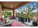 Beautiful covered patio with a variety of potted plants, ample seating, and desert landscaping at 12715 W Crestvale Dr, Peoria, AZ 85383