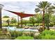 Outdoor pool with resort-style amenities including lounge chairs, waterfalls, and shade structures at 12715 W Crestvale Dr, Peoria, AZ 85383