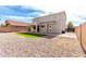 A spacious backyard featuring an artificial grass play area and low-maintenance gravel landscaping at 13408 W Mauna Loa Ln, Surprise, AZ 85379