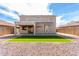 A large backyard with turf surrounded by gravel, offering a low-maintenance and inviting outdoor space at 13408 W Mauna Loa Ln, Surprise, AZ 85379