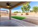 Covered backyard patio, offering shade and an outdoor ceiling fan for your comfort at 13408 W Mauna Loa Ln, Surprise, AZ 85379