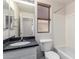 Bathroom featuring granite vanity, mirror, and window at 13408 W Mauna Loa Ln, Surprise, AZ 85379