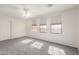 Bright bedroom featuring plush carpet, a ceiling fan, and a closet for ample storage at 13408 W Mauna Loa Ln, Surprise, AZ 85379