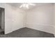Bedroom features plush carpet, a ceiling fan, and closet that adds to its comfort and functionality at 13408 W Mauna Loa Ln, Surprise, AZ 85379