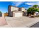 Two-story home with a large driveway and a stone-accented facade at 13408 W Mauna Loa Ln, Surprise, AZ 85379