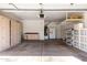 Spacious garage featuring built-in storage cabinets and shelving, providing ample space for organization at 13408 W Mauna Loa Ln, Surprise, AZ 85379