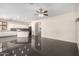 Open-concept layout with black tile flooring, and white cabinetry at 13408 W Mauna Loa Ln, Surprise, AZ 85379