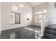 Bright living room with high ceilings, large windows, and dark flooring at 13408 W Mauna Loa Ln, Surprise, AZ 85379