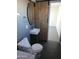 Cozy bathroom features a unique round mirror, vessel sink, dark tiled floors, and rustic sliding barn door at 13839 N 33Rd St, Phoenix, AZ 85032