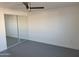 Bright bedroom with painted brick walls, modern ceiling fan, and mirrored closet doors at 13839 N 33Rd St, Phoenix, AZ 85032