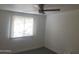 Bright bedroom featuring a ceiling fan and large window allowing natural light at 13839 N 33Rd St, Phoenix, AZ 85032