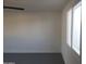 Bright bedroom with painted brick walls, modern ceiling fan, and a large window for natural light at 13839 N 33Rd St, Phoenix, AZ 85032