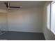 Bright bedroom with painted brick walls, modern ceiling fan, and a large window for natural light at 13839 N 33Rd St, Phoenix, AZ 85032