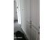 Hallway with white cabinets and drawers showcasing classic hardware, plus an open doorway at 13839 N 33Rd St, Phoenix, AZ 85032