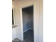 Bright laundry room with brick walls, gray flooring, and white shelving ready for organizing cleaning supplies at 13839 N 33Rd St, Phoenix, AZ 85032