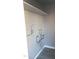 Bright laundry room with brick walls, gray flooring, and white shelving ready for organizing cleaning supplies at 13839 N 33Rd St, Phoenix, AZ 85032