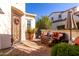 Inviting outdoor patio with stylish seating, decorative plants, and a wrought iron gate at 1620 E Sattoo Way, Queen Creek, AZ 85140