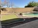 Backyard with putting green, mature trees and a refreshing in-ground pool at 16823 S 27Th Ave, Phoenix, AZ 85045