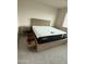 Bedroom with mattress on wooden frame and bedside tables at 16823 S 27Th Ave, Phoenix, AZ 85045