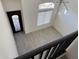 Bright, spacious foyer with a decorative front door, clerestory window, and modern light fixture at 16823 S 27Th Ave, Phoenix, AZ 85045