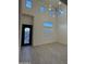 High ceiling foyer with modern light fixture and decorative glass front door at 16823 S 27Th Ave, Phoenix, AZ 85045