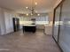 Bright kitchen with stainless steel appliances, a large island, and ample counter space at 16823 S 27Th Ave, Phoenix, AZ 85045