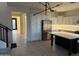 Well-lit kitchen featuring a large island, stainless steel refrigerator, and white cabinets at 16823 S 27Th Ave, Phoenix, AZ 85045