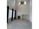 Bright living room with a fireplace, ceiling fan, and neutral tile floors at 16823 S 27Th Ave, Phoenix, AZ 85045