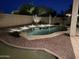 Inviting backyard pool at night, surrounded by desert landscaping and subtle lighting at 16823 S 27Th Ave, Phoenix, AZ 85045