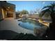 Backyard pool surrounded by desert landscaping and a covered patio area at 16823 S 27Th Ave, Phoenix, AZ 85045