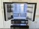 Interior view of stainless-steel refrigerator with glass shelves and storage drawers at 16823 S 27Th Ave, Phoenix, AZ 85045