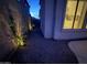 Side yard featuring landscape lighting, plants, and decorative rock at 16823 S 27Th Ave, Phoenix, AZ 85045