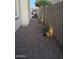 Side yard featuring landscape lighting, plants, and decorative rock at 16823 S 27Th Ave, Phoenix, AZ 85045
