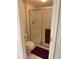 Bathroom featuring glass enclosed shower with red towel and tiled floors at 17404 N 99Th Ave # 136, Sun City, AZ 85373