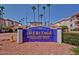 Entrance sign for The Heritage Senior Condominiums with palm trees at 17404 N 99Th Ave # 136, Sun City, AZ 85373