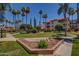 Manicured community grounds, including lush lawns and palm trees at 17404 N 99Th Ave # 136, Sun City, AZ 85373